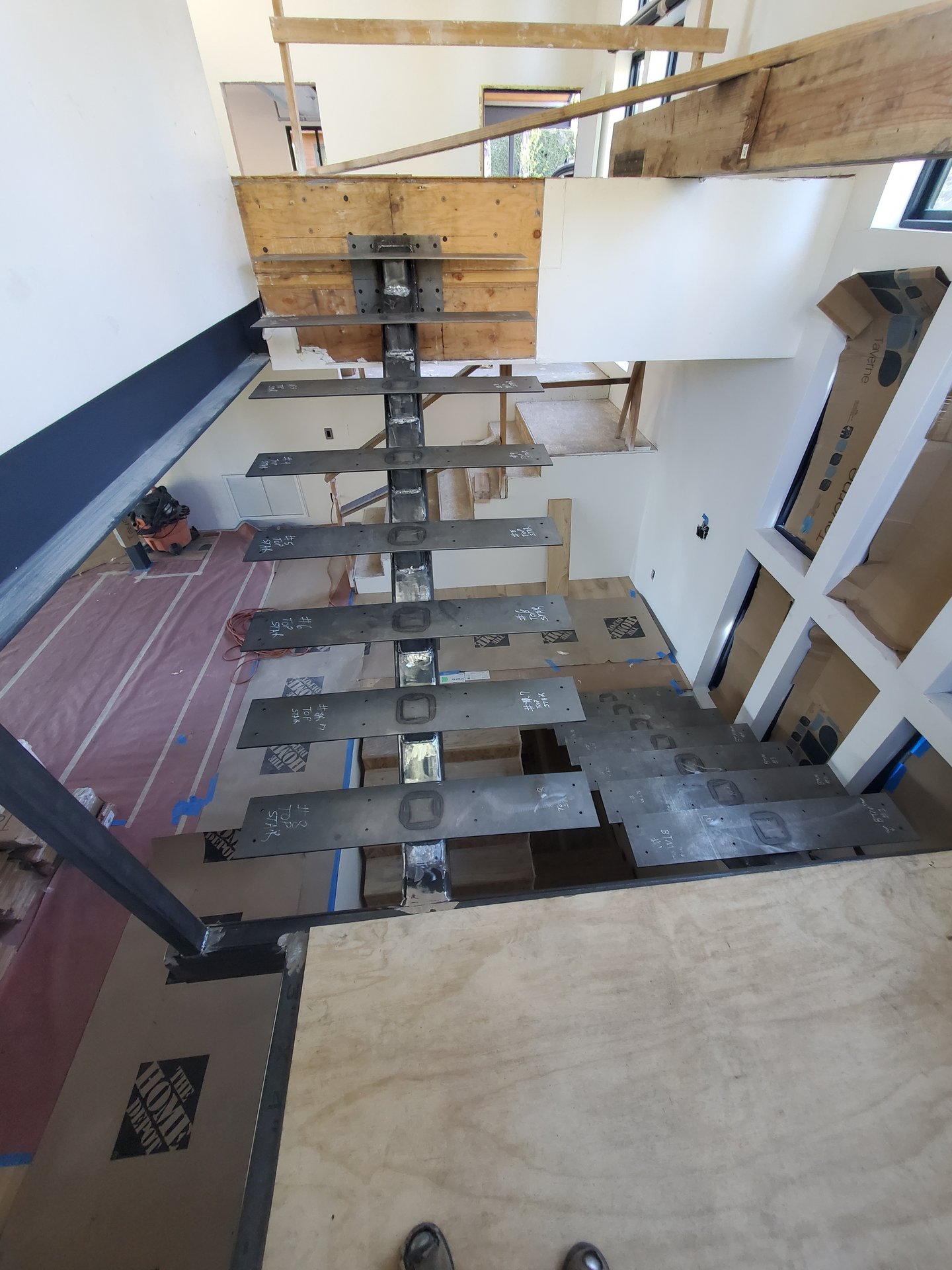 Fabricated steel stair treads and stringer for a custom floating staircase