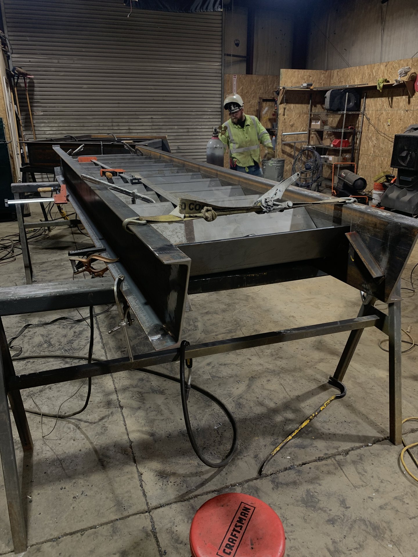 Battle Born welder fabricating an exterior steel staircase at night