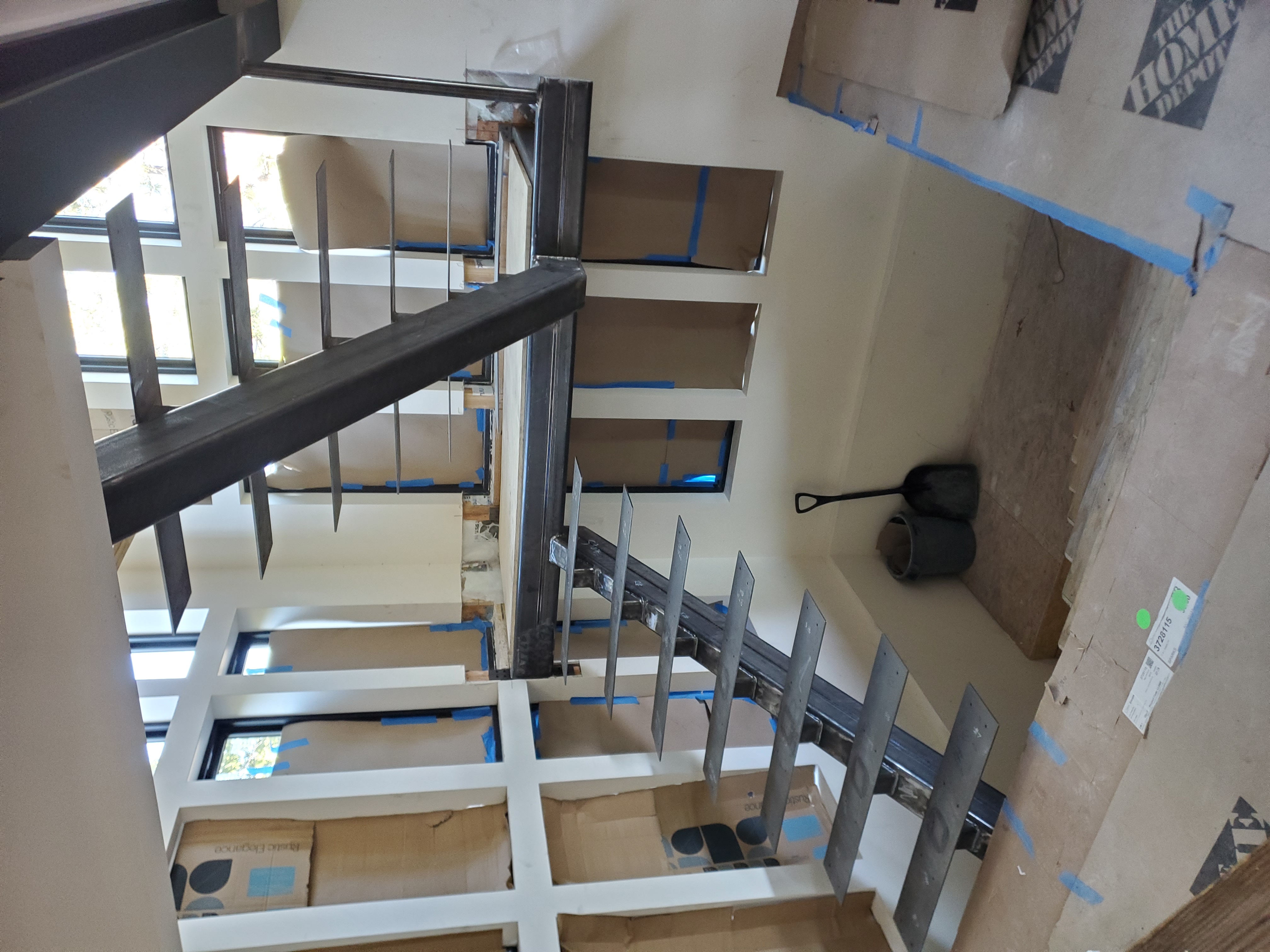 Custom steel stair stringer and landing detail mid-install at Bogowolski Residence